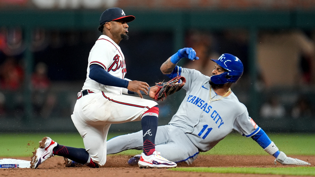 Kansas City Royals' Maikel Garcia (11) steals the base against Atlanta Braves second baseman Ozzie Albies (1) during the third inning of an opening-day baseball game, Friday, March 27, 2026, in Atlanta. (AP Photo/Mike Stewart)