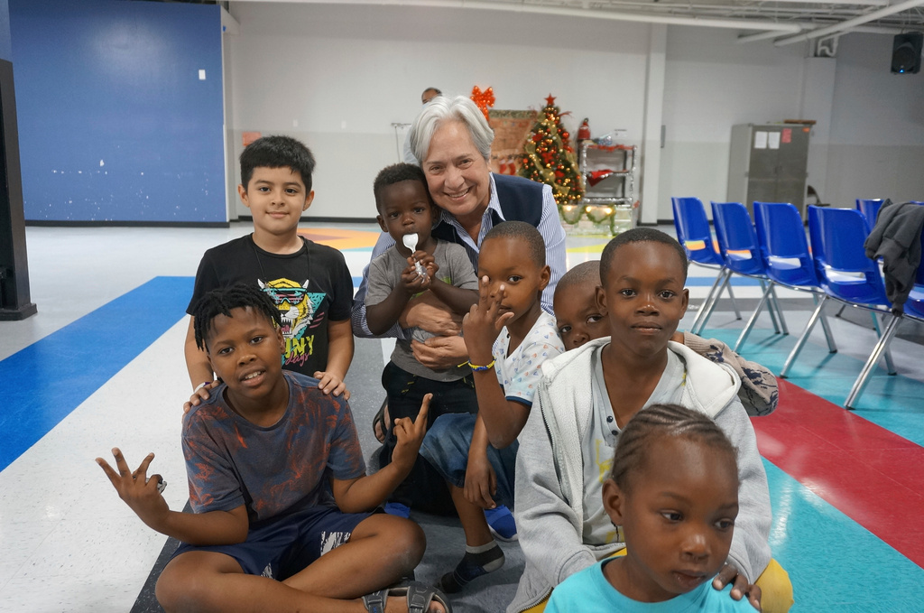 FILE - Sister Norma Pimentel, the director of Catholic Charities of the Rio Grande Valley, plays with migrant children on the floor of the Humanitarian Respite Center in McAllen, Texas, Dec. 15, 2022. (AP Photo/Giovanna Dell'Orto, file)