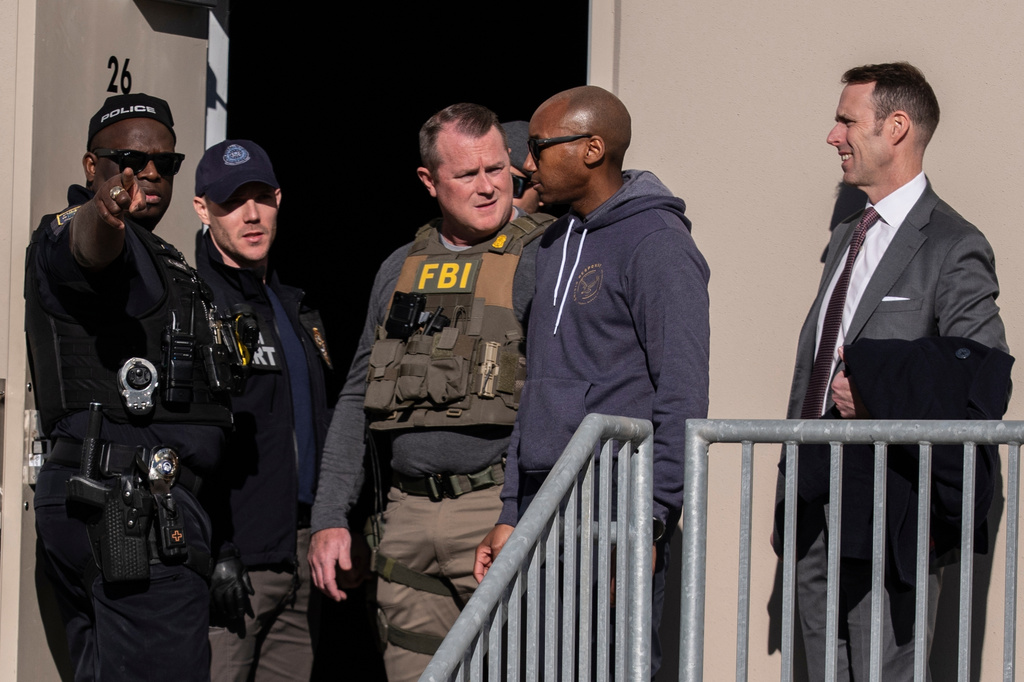 FILE - FBI agents are seen at the Fulton County Election Hub and Operation Center, Jan. 28, 2026, in Union City, Ga., near Atlanta. (AP Photo/Mike Stewart, File)