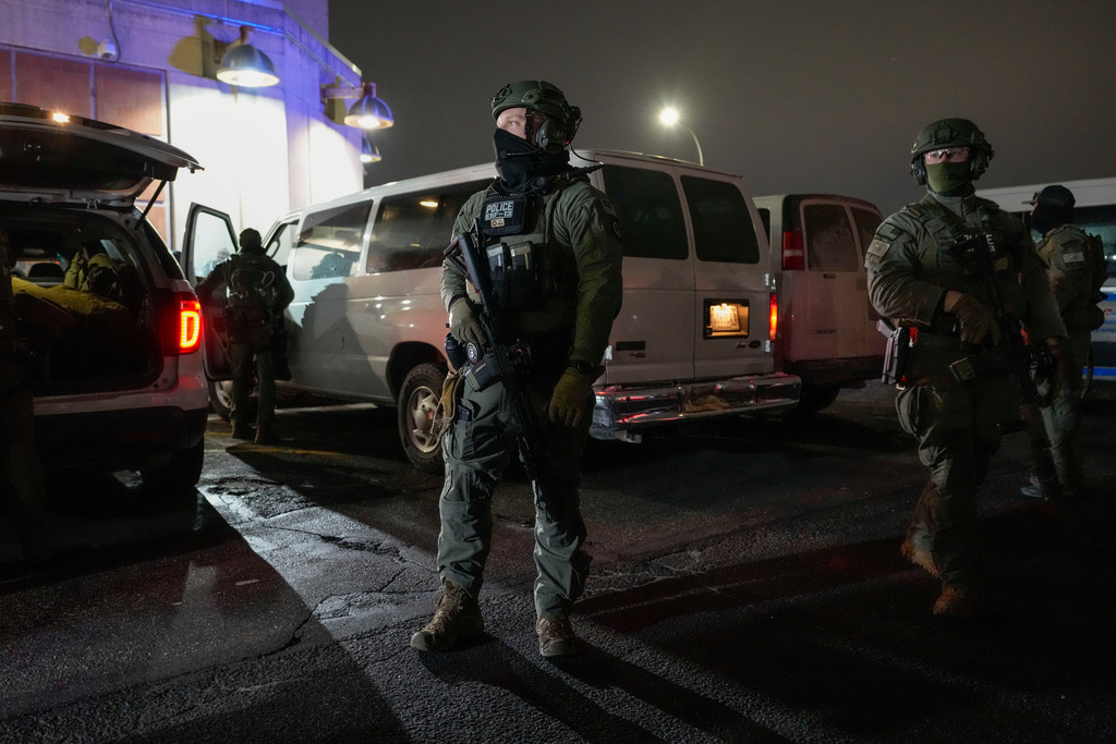 Federal law enforcement personnel patrol outside the Metropolitan Detention Center as they await the arrival of captured Venezuelan President Nicolas Maduro, Saturday, Jan. 3, 2026, in New York. (AP Photo/Yuki Iwamura)