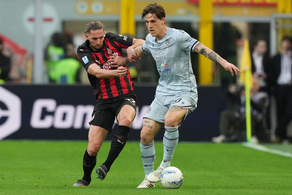 AC Milan's Adrien Rabiot, left, and Udinese's Nicolo Zaniolo fight for the ball during the Serie A soccer match between AC Milan and Udinese, in Milan, Italy, Saturday, April 11, 2026. (AP Photo/Antonio Calanni)