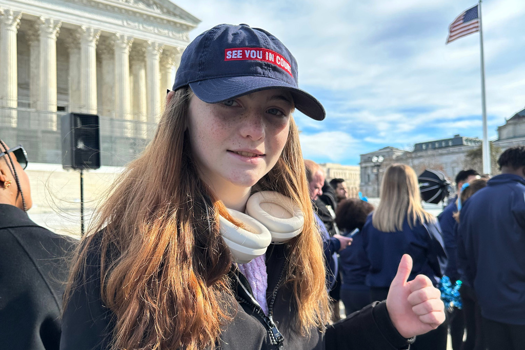 This Jan. 2026 photo provided by Sara Tirrell shows Parker Tirrell of New Hampshire outside of the U.S. Supreme Court at a rally supporting rights for transgender athletes in Washington. (Sara Tirrell via AP).
