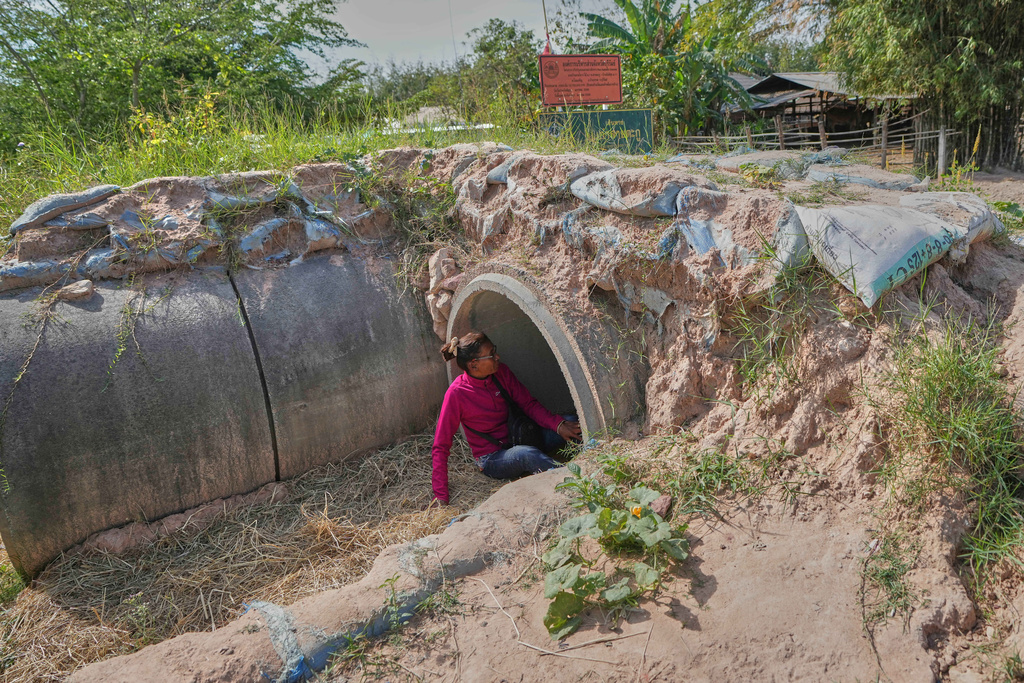 A Thai resident takes shelter in Buriram province, Thailand, Friday, Dec. 12, 2025, following renewed border conflict between Thailand and Cambodia. (AP Photo/Sakchai Lalit)
