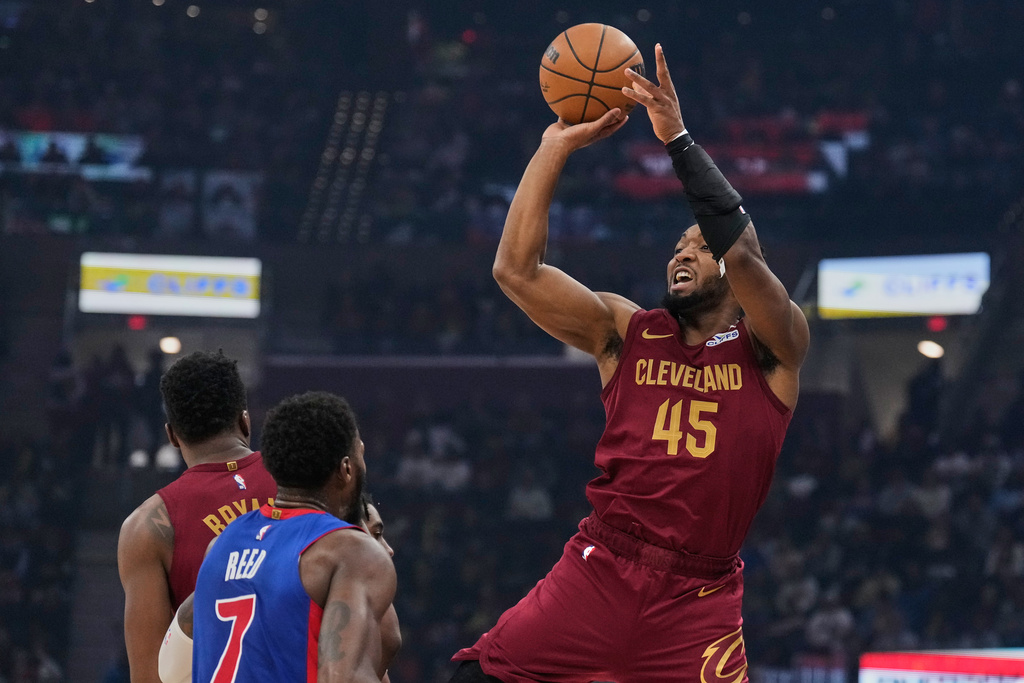 Cleveland Cavaliers guard Donovan Mitchell (45) shoots over Detroit Pistons forward Paul Reed (7) in the first half of an NBA basketball game Sunday, Jan. 4, 2026, in Cleveland. (AP Photo/Sue Ogrocki)