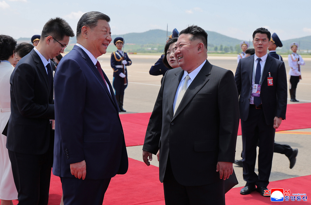 In this photo provided by the North Korean government, North Korean leader Kim Jong Un, front right, greets Chinese President Xi Jinping, center left, on the latter's arrival at the airport in Pyongyang, Monday, June 8, 2026. Independent journalists were not given access to cover the event depicted in this image distributed by the North Korean government. The content of this image is as provided and cannot be independently verified. Korean language watermark on image as provided by source reads: "KCNA" which is the abbreviation for Korean Central News Agency. (Korean Central News Agency/Korea News Service via AP)