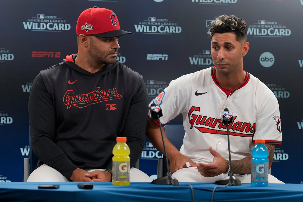 Cleveland Guardians shortstop Brayan Rocchio, right, and interpreter Agustin Rivero, left, participate in a news conference after Game 2 of the American League Wild Card baseball playoff series against the Detroit Tigers in Cleveland, Wednesday, Oct. 1, 2025. (AP Photo/Sue Ogrocki)