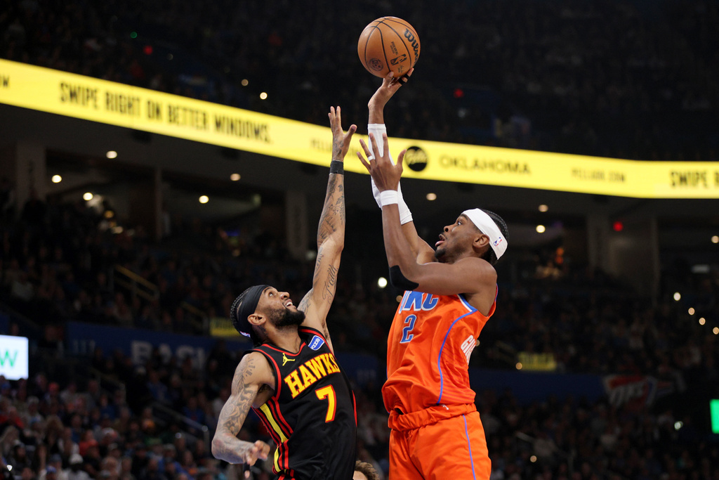 Oklahoma City Thunder guard Shai Gilgeous-Alexander (2) shoots over Atlanta Hawks guard Nickeil Alexander-Walker (7) during the second half of an NBA basketball game Monday, Dec. 29, 2025, in Oklahoma City. (AP Photo/Nate Billings)