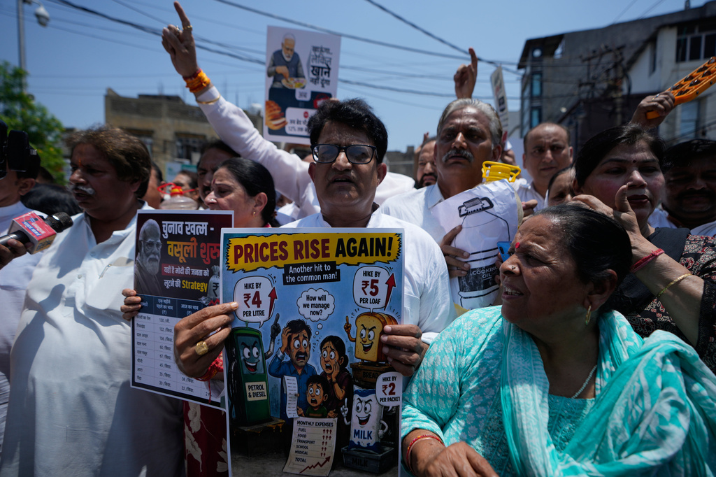 Congress party supporters hold placards during a protest against the rising prices of essential commodities, in Jammu, India, Wednesday, June 3, 2026. (AP Photo/Channi Anand)