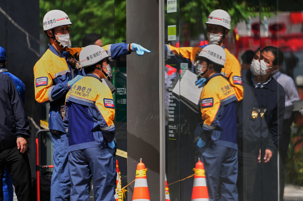 Tokyo Fire Department personnel examine the scene after a person allegedly sprayed a substance that caused an odor, in Tokyo, Japan, Monday, May 25, 2026. (AP Photo/Eugene Hoshiko)