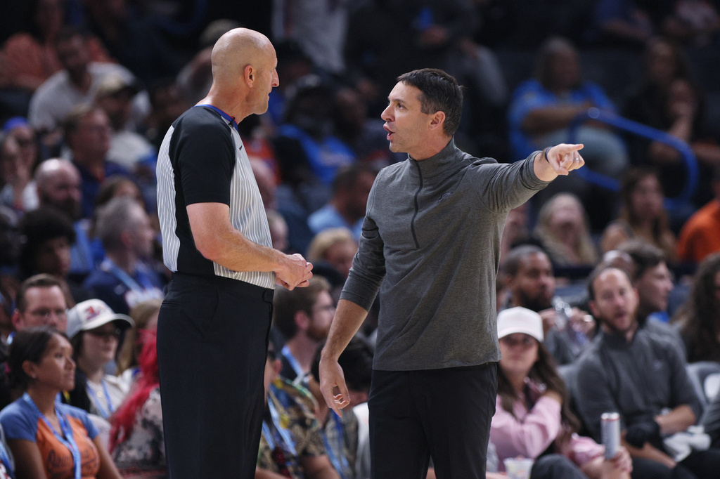 Oklahoma City Thunder head coach Mark Daigneault, right, talks to referee Eric Dalen, left, during the second half of a preseason NBA basketball game against the Indiana Pacers, Tuesday, Oct. 13, 2026, in Oklahoma City. (AP Photo/Nate Billings)