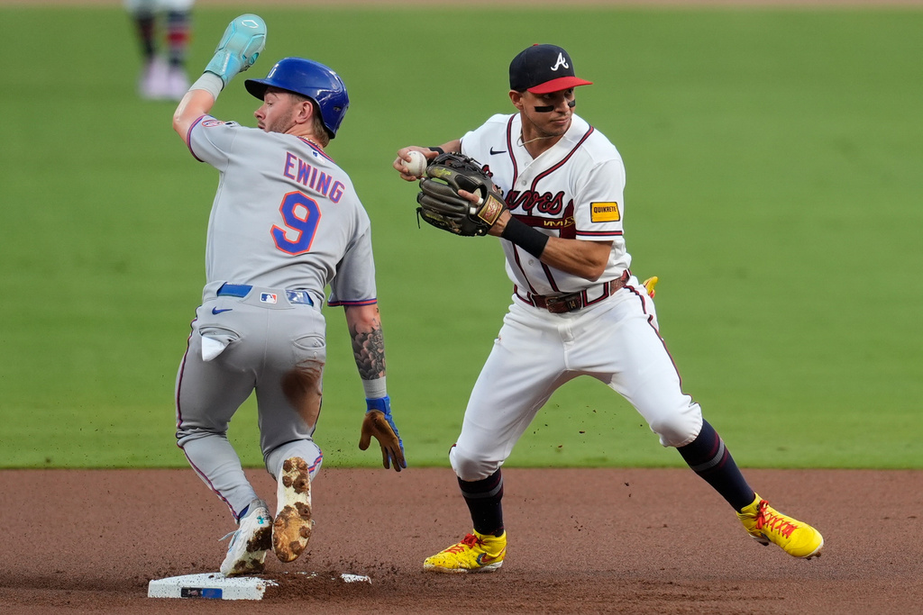 Atlanta Braves left fielder Mauricio Dubón (14) makes the tag on New York Mets' A.J. Ewing (9) in the first inning of a baseball game, Wednesday, Aug. 12, 2026, in Atlanta. (AP Photo/Mike Stewart)