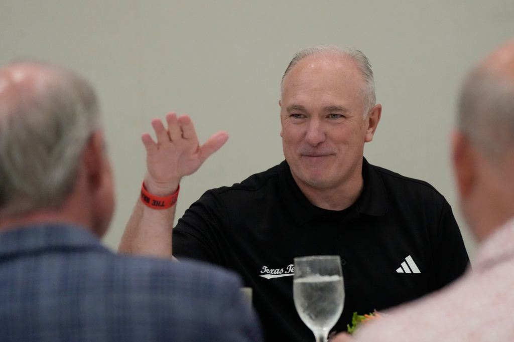 Texas Tech football coach Joey McGuire talks with attendees before speaking at The Houston Touchdown Club luncheon, Wednesday, June 10, 2026, in Houston. (AP Photo/David J. Phillip)