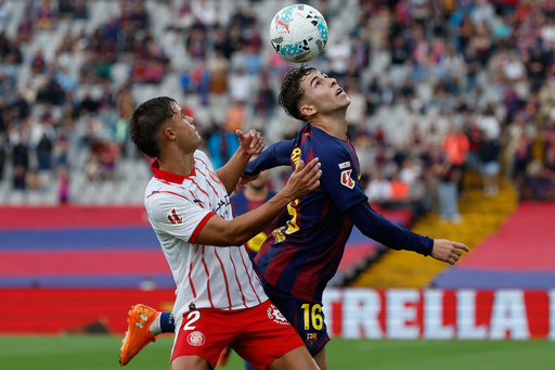 Girona's Hugo Rincon, left, and Barcelona's Fermin Lopez fight for the ball during a La Liga soccer match between Barcelona and Girona in Barcelona, Spain, Saturday, Oct. 18, 2025. AP Photo/Joan Monfort) Girona's Hugo Rincon, left, and Barcelona's Fermin Lopez fight for the ball during a La Liga soccer match between Barcelona and Girona in Barcelona, Spain, Saturday, Oct. 18, 2025. AP Photo/Joan Monfort)