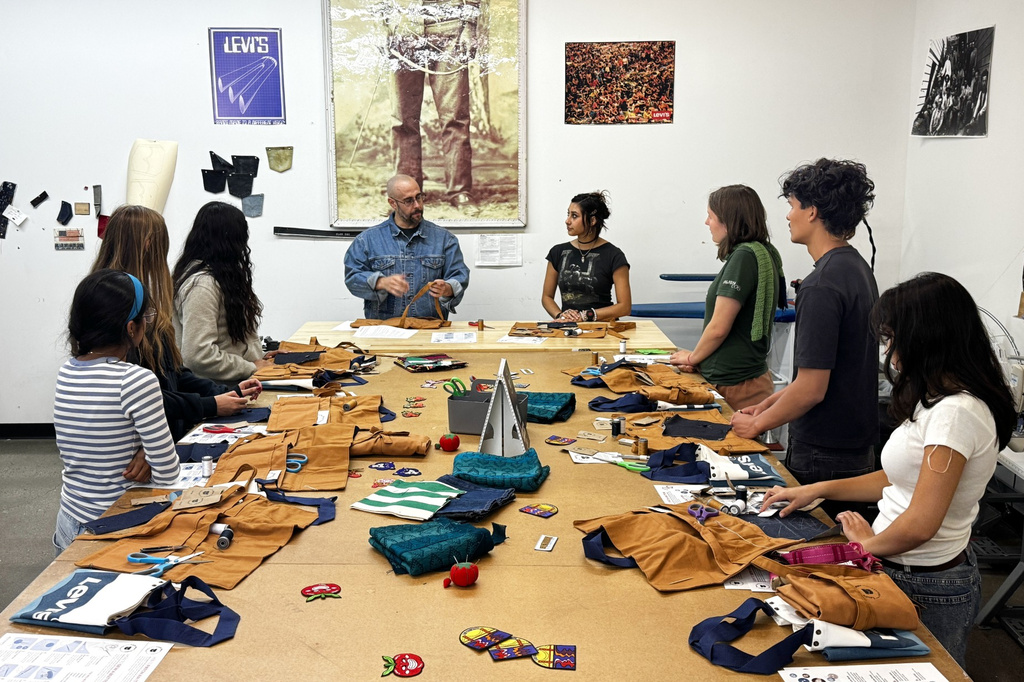Levi’s employees teach students during a sewing workshop at a Levi's retail store in downtown San Francisco, Wednesday, July 22, 2026. (AP Photo/Terry Chea)