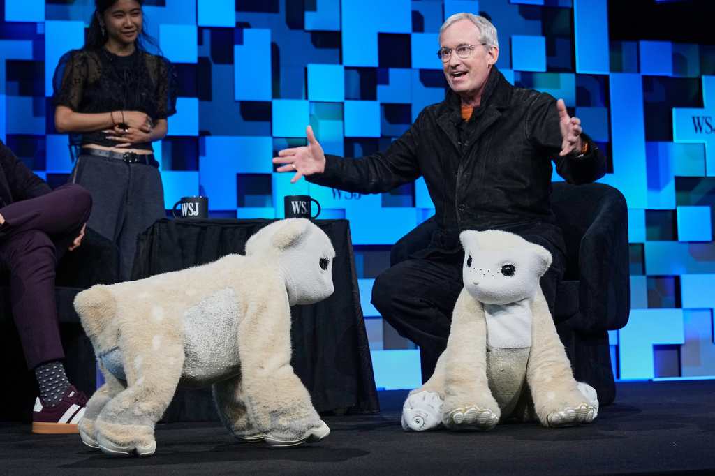 Colin Angle, longtime CEO of Roomba, unveils a four-legged prototype of artificial pets Winston, left, and Daphne, called Familiars, at The WSJ Future of Everything, in New York, Monday, May 4, 2026. (AP Photo/Richard Drew)