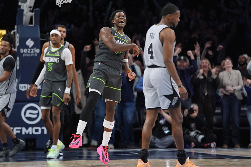 Minnesota Timberwolves guard Anthony Edwards, center, celebrates as time in an NBA basketball game against the San Antonio Spurs, Sunday, Jan. 11, 2026, in Minneapolis. (AP Photo/Abbie Parr)
