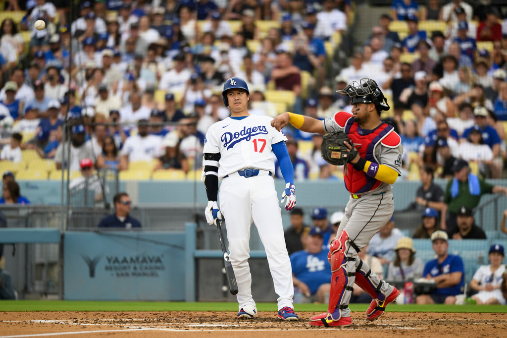Los Angeles Dodgers' Shohei Ohtani (17) reacts as Arizona Diamondbacks catcher Gabriel Moreno throws during the third inning of a baseball game in Los Angeles, Sunday, July 12, 2026. (AP Photo/Kyusung Gong)