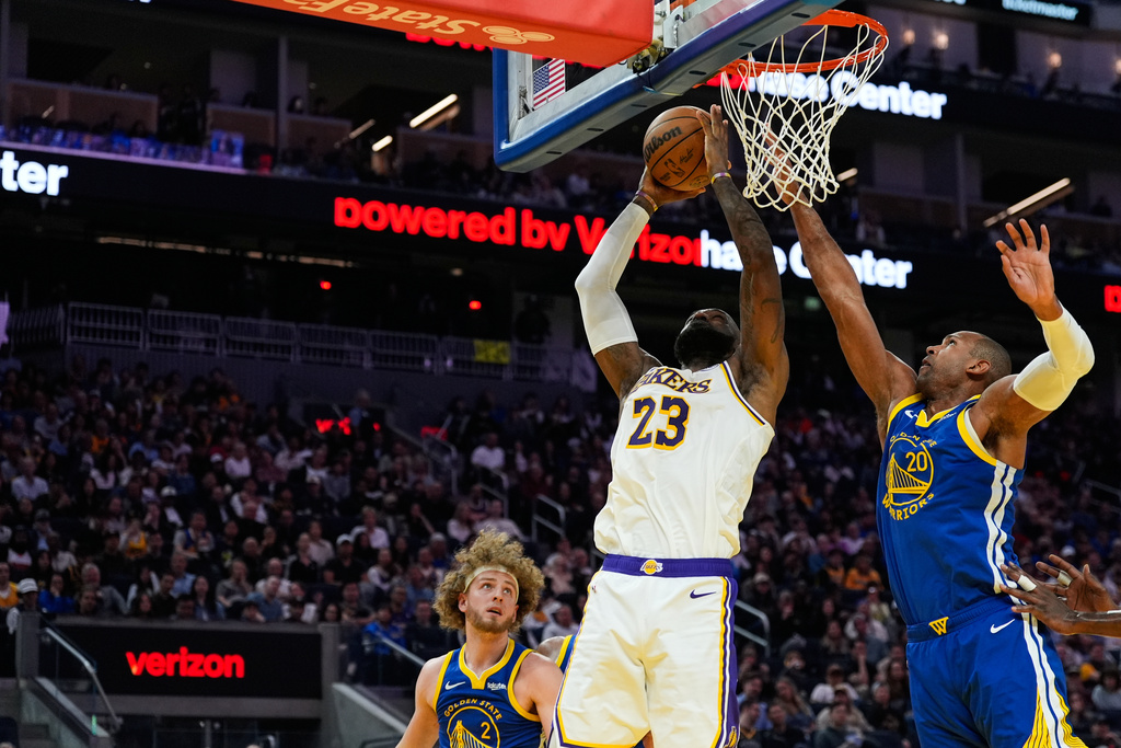 Los Angeles Lakers forward LeBron James (23) shoots while defended by Golden State Warriors center Al Horford (20) during the first half of an NBA basketball game, Saturday, Feb. 28, 2026, in San Francisco. (AP Photo/Godofredo A. Vásquez)