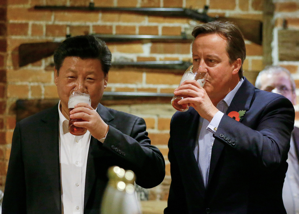 FILE - In this Thursday, Oct. 22, 2015 file photo, Britain's Prime Minister David Cameron, right, drinks beer with Chinese President Xi Jinping, at a pub in Princess Risborough, near Chequers, England. (AP Photo/Kirsty Wigglesworth, File)