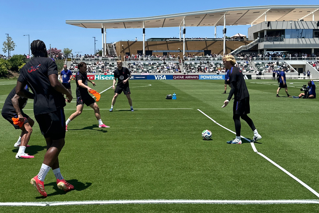 United States goalkeeper Chris Brady, right, prepares to kick the ball to teammates during the national team's first practice at its World Cup soccer tournament training base in Irvine, Calif., Monday, June 8, 2026. (AP Photo/Greg Beacham)