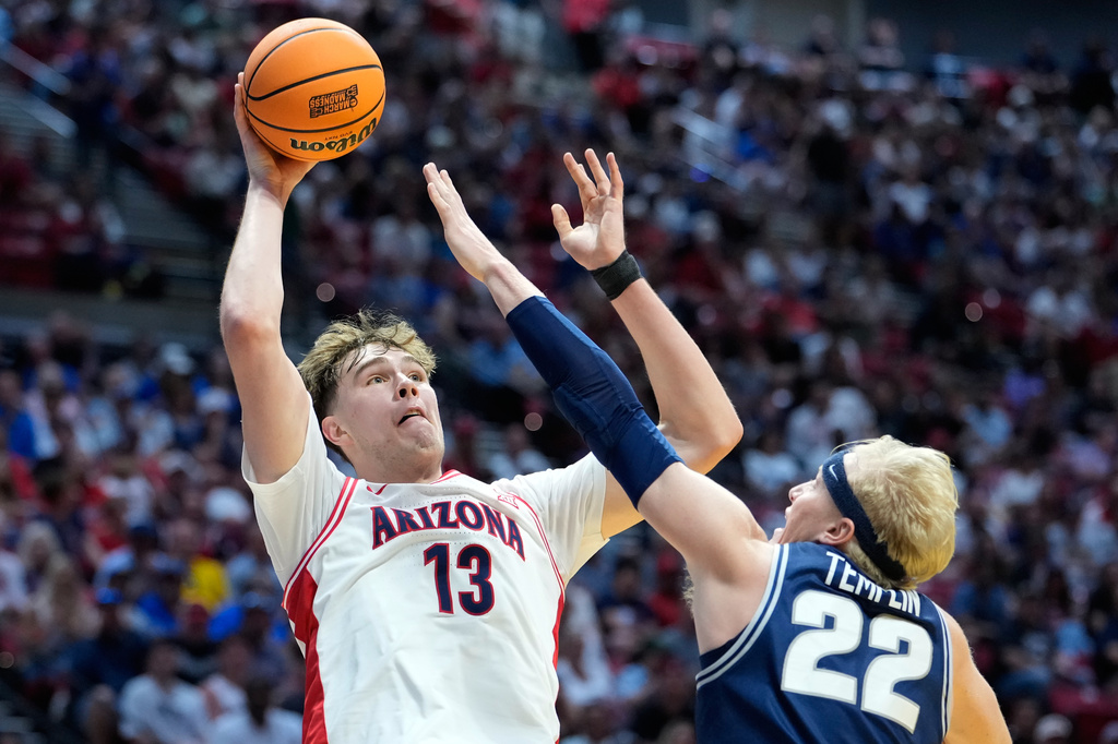 FILE - Arizona center Motiejus Krivas (13) shoots over Utah State forward Karson Templin (22) during the first half of a game in the second round of the NCAA college basketball tournament, March 22, 2026, in San Diego. (AP Photo/Mark J. Terrill, File)
