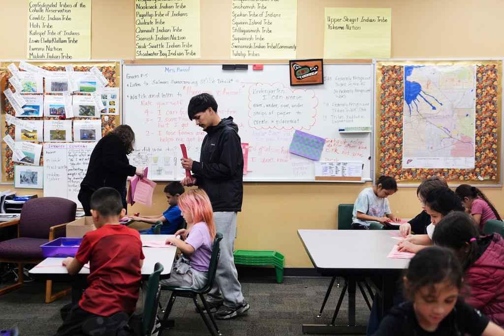 Chief Leschi Schools senior Gerald Dillon, 18, helps during a weaving exercise in a culture class for second graders as he serves as a teaching assistant through the school's career and technical education program, Wednesday, March 18, 2026, at Chief Leschi Schools in Puyallup, Wash. (AP Photo/Lindsey Wasson)