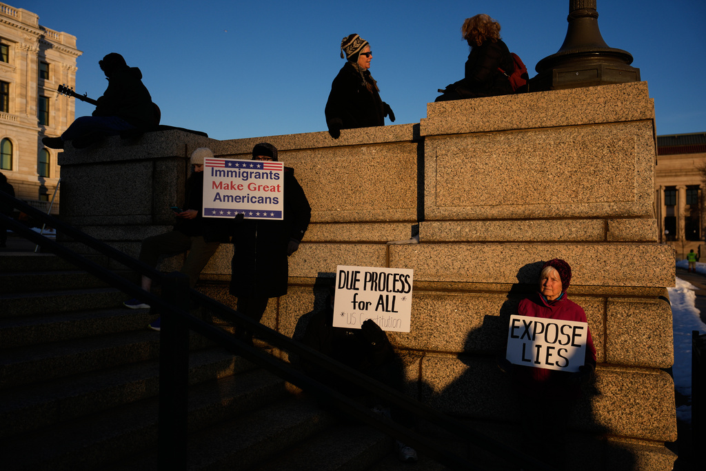 People gather for a vigil honoring Renee Good, who was fatally shot by an ICE officer in Minneapolis earlier in the week, at the Minnesota State Capitol in St. Paul, Minn., Friday, Jan. 9, 2026. (AP Photo/John Locher)