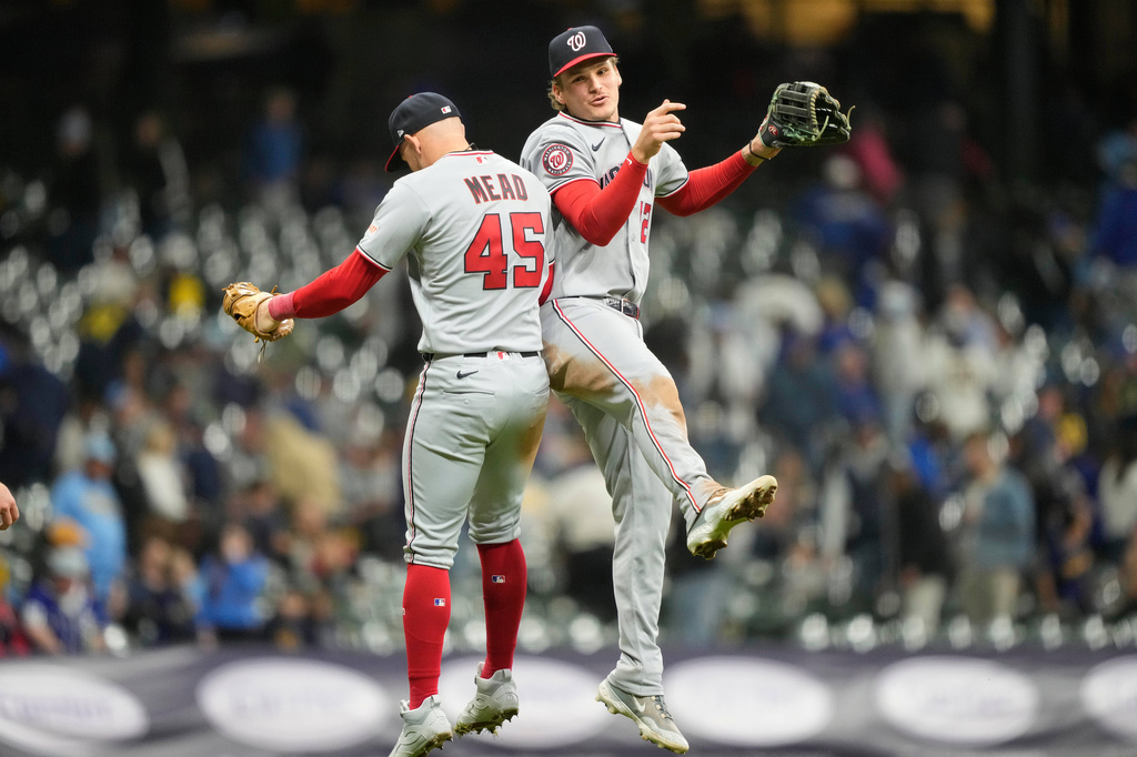 Washington Nationals first baseman Curtis Mead (45) and Brady House, right, react after winning a baseball game against the Milwaukee Brewers, Friday, April 10, 2026, in Milwaukee. (AP Photo/Kayla Wolf)
