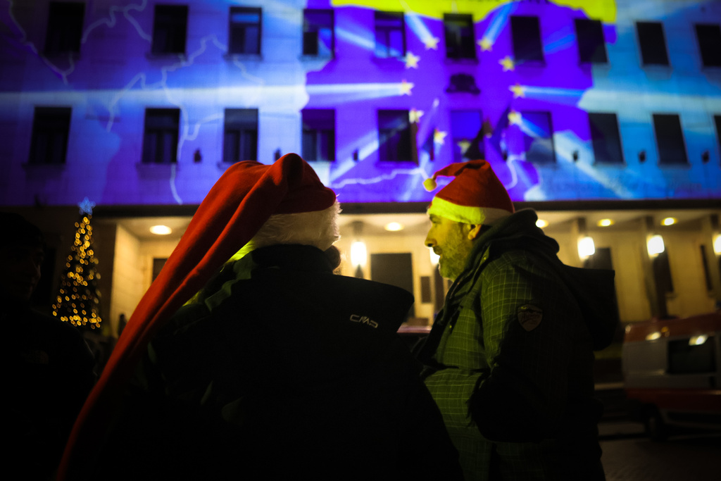A map of Bulgaria with the EU symbol is projected on the Bulgarian National Bank as people celebrate New Year's Eve and Bulgaria's adoption of the euro in Sofia, Bulgaria, Thursday Jan. 1, 2026. (AP Photo/Valentina Petrova)