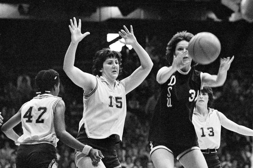 FILE - Louisiana State's Maree Bennie (15) throws up her arms in defense as Delta State's Wanda Hairston of Delta State passes the ball during the finals of the AIAW national basketball championships in Minneapolis, Minn., March 28, 1977. (AP Photo/Jim Mone, File)