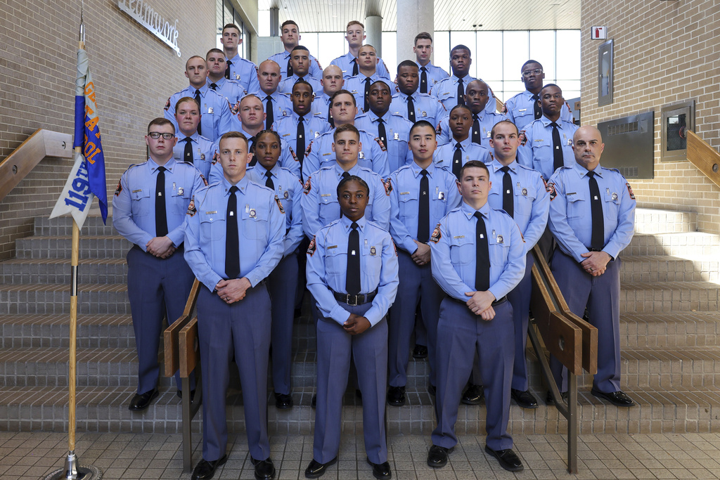 Lucy Kemp, the middle daughter of Georgia Gov. Brian Kemp, stands at the far left on the third row from the bottom as a member of her graduating class of new Georgia state troopers in Forsyth, Ga., Friday, Sept. 5, 2025. (Georgia State Patrol via AP)