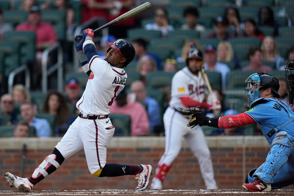 Atlanta Braves second baseman Ozzie Albies (1) hits a sacrifice fly for an RBI in the first inning of a baseball game against the Toronto Blue Jays, Tuesday, June 2, 2026, in Atlanta. (AP Photo/Mike Stewart)
