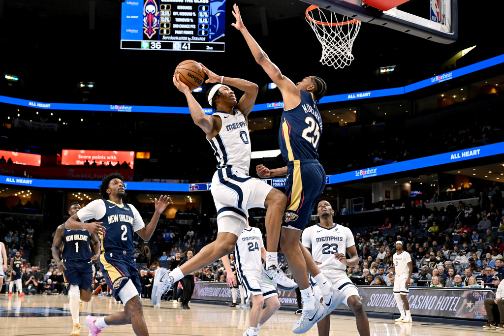 Memphis Grizzlies forward Jaylen Wells (0) jumps to shoot against New Orleans Pelicans forward Trey Murphy III (25) in the first half of an NBA basketball game Friday, Jan. 23, 2026, in Memphis, Tenn. (AP Photo/Brandon Dill)