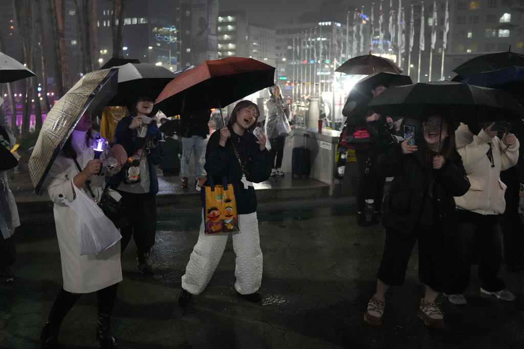 Fans of K-pop band BTS react outside of the stadium where K-pop band BTS is performing the World Tour Arirang in Goyang, South Korea, Thursday, April 9, 2026. (AP Photo/Lee Jin-man)