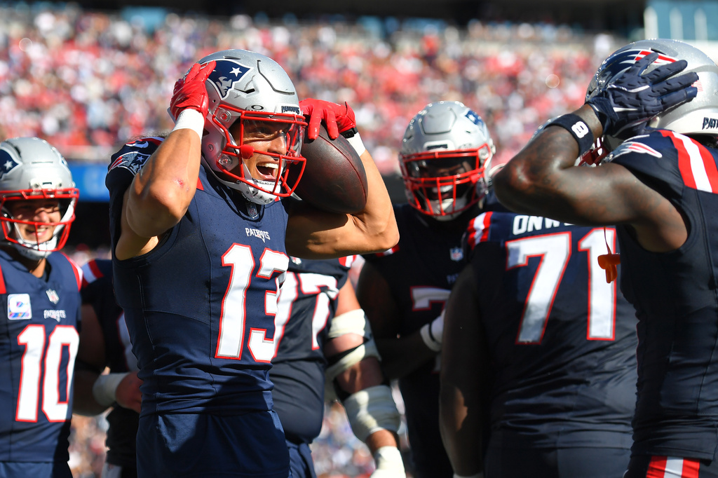 New England Patriots wide receiver Mack Hollins (13) celebrates with teammates after scoring a touchdown against the Carolina Panthers during the second half of an NFL football game, Sunday, Sept. 28, 2025, in Foxborough, Mass. (AP Photo/Steven Senne)