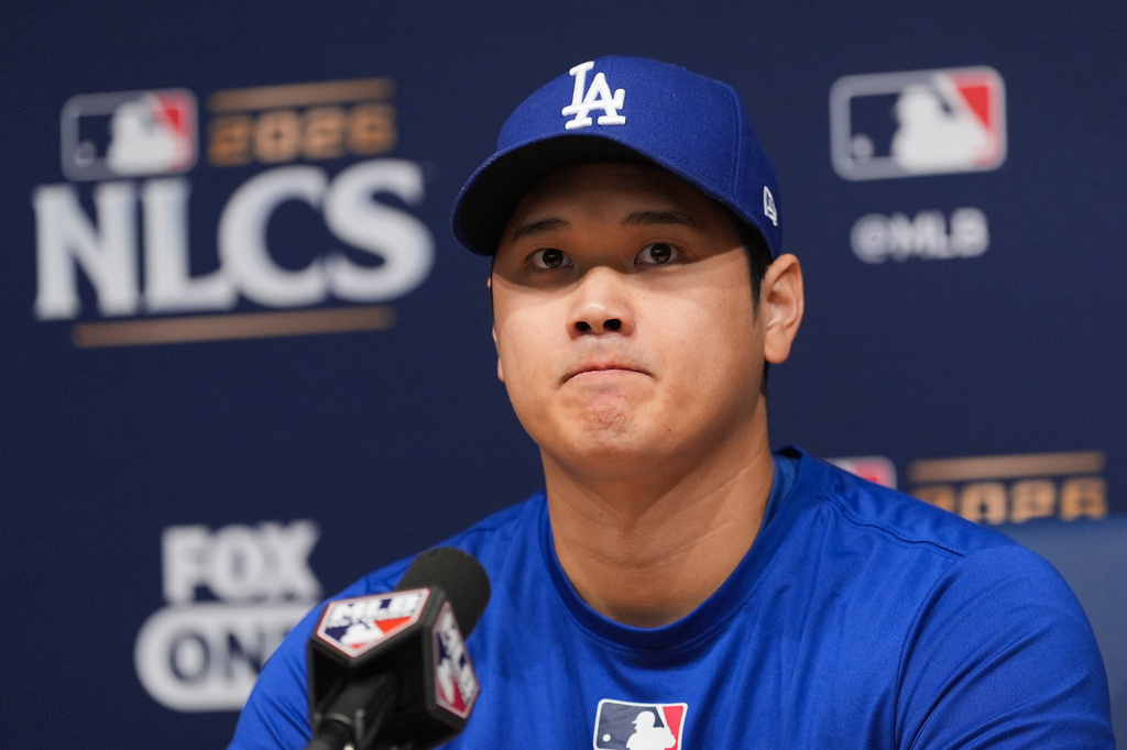 Los Angeles Dodgers' Shohei Ohtani listens to questions from the media during a news conference ahead of Game 3 of baseball's National League Championship Series against the Milwaukee Brewers, Tuesday, Oct. 13, 2026, in Los Angeles. (AP Photo/Jae C. Hong)