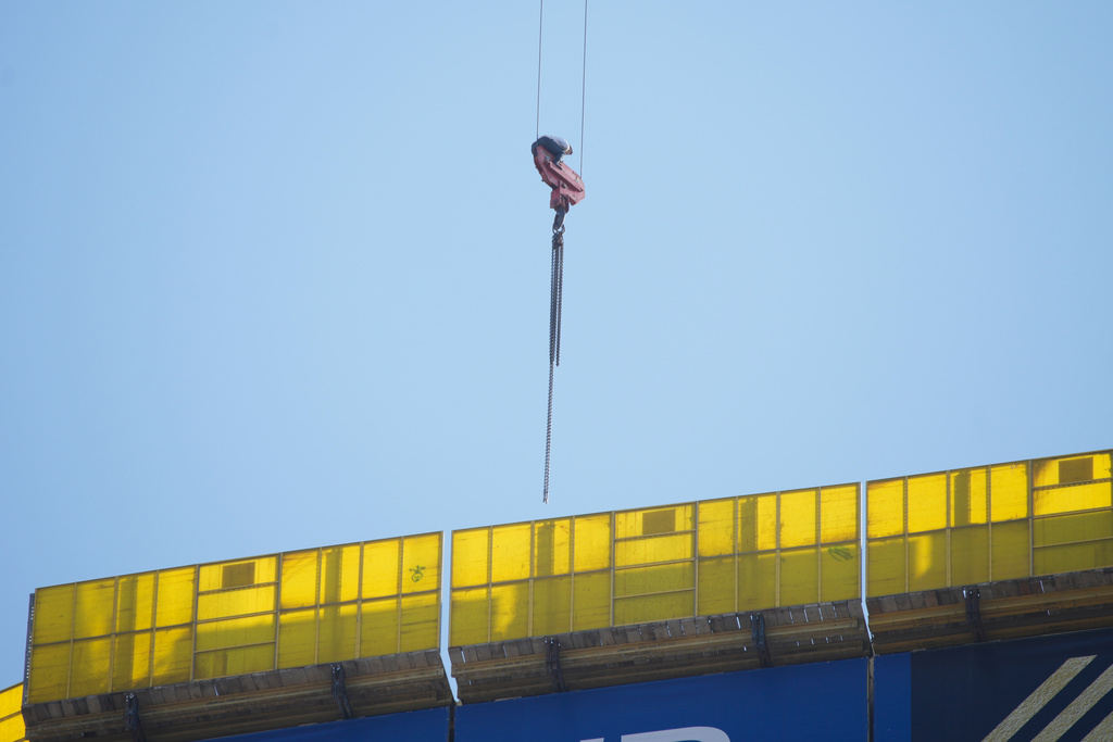 A teenager is seen trapped on a crane platform atop a skyscraper, where he dangled 36 stories up in the air for seven hours before being rescued, in Jerusalem Monday, Nov. 24, 2025. (AP Photo/Ohad Zwigenberg)