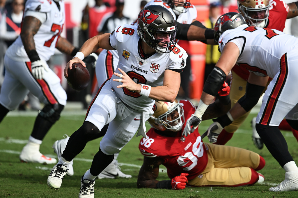 Tampa Bay Buccaneers quarterback Baker Mayfield (6) rolls out against the San Francisco 49ers during the first half of an NFL football game in Tampa, Fla., Sunday, Oct. 12, 2025. (AP Photo/Jason Behnken)