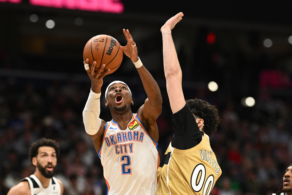 Oklahoma City Thunder guard Shai Gilgeous-Alexander (2) goes to the basket against Washington Wizards forward Tristan Vukcevic (00) during the first half of an NBA basketball game, Saturday, March 21, 2026, in Washington. (AP Photo/Nick Wass)