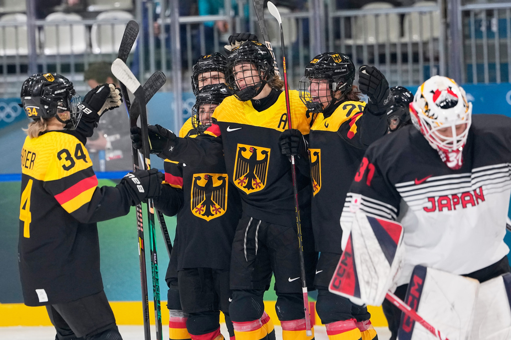 Germany's Laura Kluge, center, celebrates with teammates after scoring her sides fifth goal during a preliminary round match of women's ice hockey between Germany and Japan at the 2026 Winter Olympics, in Milan, Italy, Saturday, Feb. 7, 2026. (AP Photo/Petr David Josek)