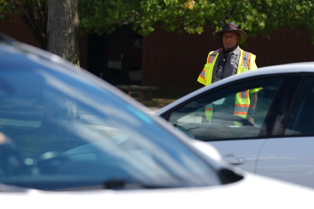 School crossing guard Anthony Taylor waits to cross the street, Wednesday, Sept. 3, 2025, in Indianapolis. (AP Photo/Darron Cummings)