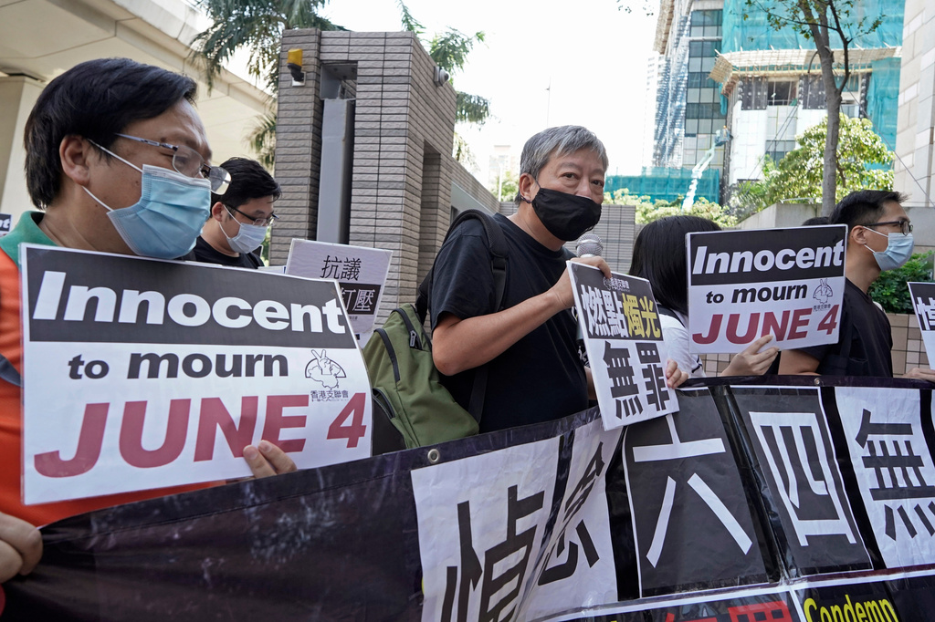 FILE - Pro-democracy activists, including Lee Cheuk-Yan, center, arrive at a court in Hong Kong after being charged with joining an unauthorized assembly on a vigil last June 4 to commemorate the anniversary of the 1989 Tiananmen crackdown in Hong Kong on Oct. 15, 2020. (AP Photo/Kin Cheung, File)