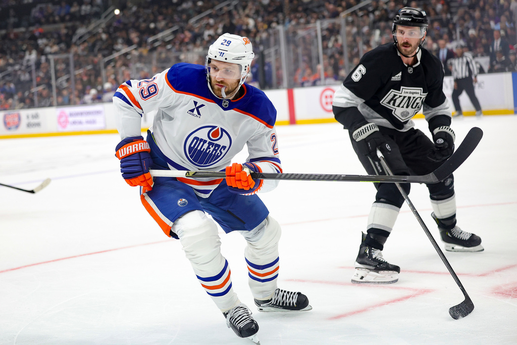 Edmonton Oilers center Leon Draisaitl, left, skates against Los Angeles Kings defenseman Joel Edmundson during the first period of an NHL hockey game Thursday, Feb. 26, 2026 in Los Angeles. (AP Photo/Ryan Sun)