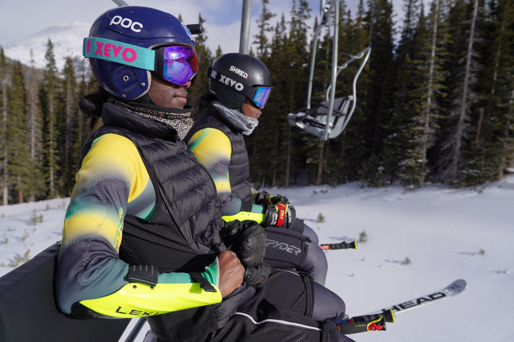 Sisters Henniyah Rivers, front, and Helaina Rivers ride a ski lift as they get set for a training run in the slalom, Wednesday, Dec, 10, 2025, at Loveland Ski Area in Dillon, Colo. (AP Photo/Brittany Peterson)