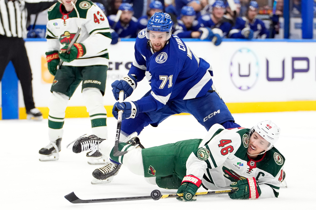Minnesota Wild defenseman Jared Spurgeon (46) falls down as he chases the puck against Tampa Bay Lightning center Anthony Cirelli (71) during the second period of an NHL hockey game Tuesday, March 24, 2026, in Tampa, Fla. (AP Photo/Chris O'Meara)
