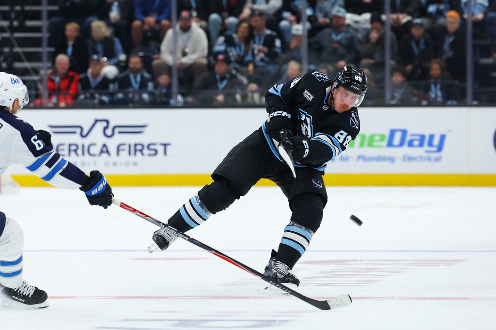 Utah Mammoth defenseman Nate Schmidt (88) shoots the puck during the third period of an NHL hockey game against the Winnipeg Jets, Tuesday, April 14, 2026, in Salt Lake City. (AP Photo/Melissa Majchrzak)