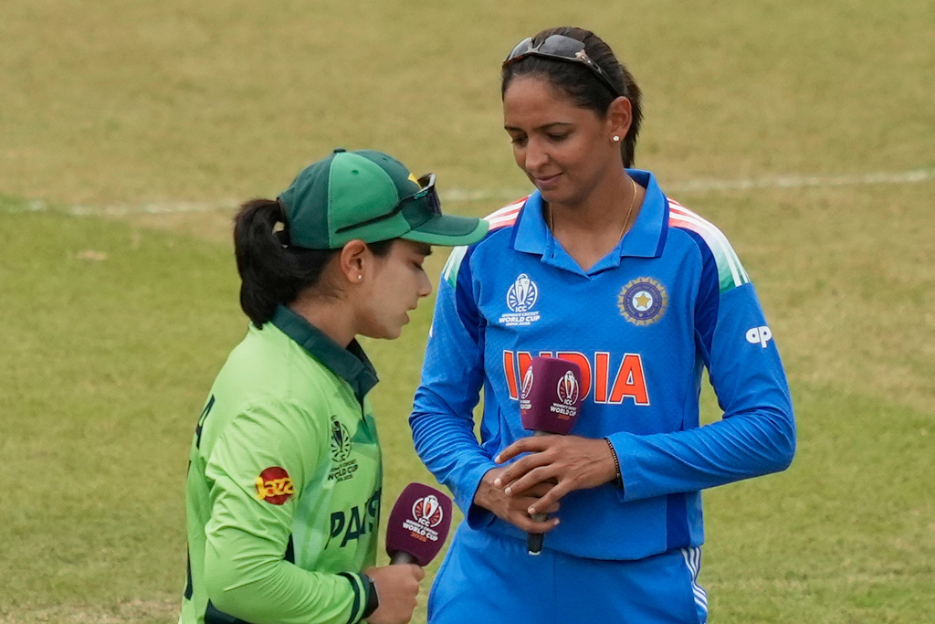 India's captain Harmanpreet Kaur, right, and Pakistan's captain Fatima Sana look on before the ICC Women's Cricket World Cup match between India and Pakistan at Premadasa Stadium in Colombo, Sri Lanka, Sunday, Oct, 5, 2025. (AP Photo/Eranga Jayawardena)