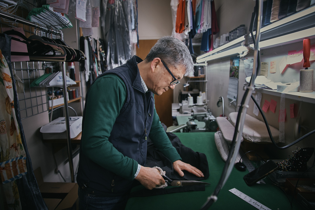 Tailor, Kil Bae, works inside his shop on Friday, March 27, 2026, in New York. (AP Photo/Andres Kudacki)
