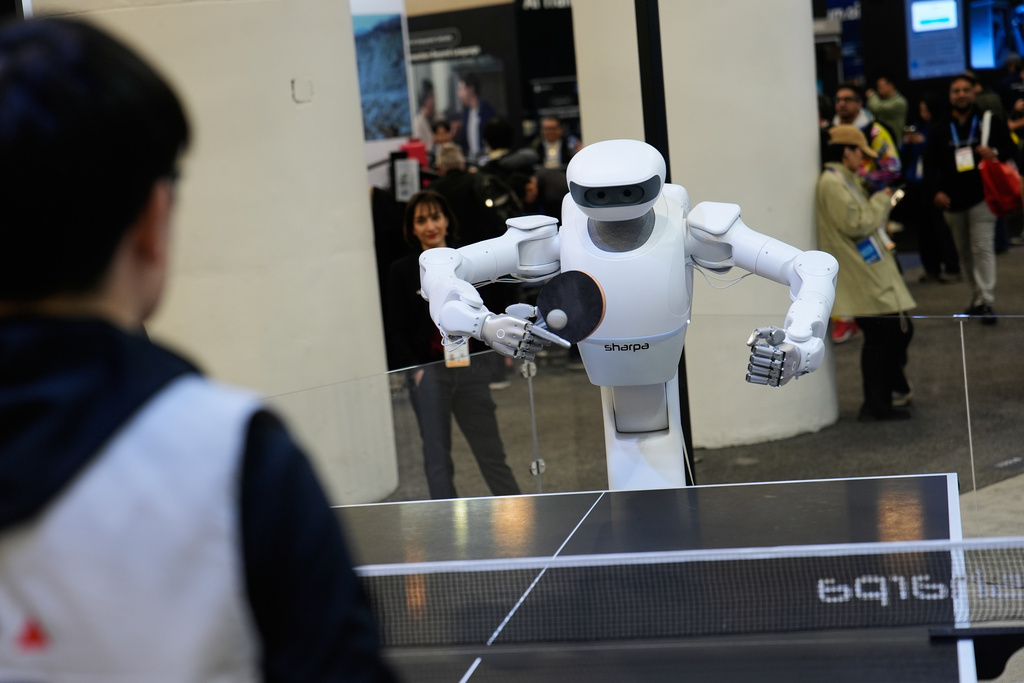 The Sharpa North robot plays table tennis with a person at the Sharpa booth during the CES tech show Wednesday, Jan. 7, 2026, in Las Vegas. (AP Photo/John Locher)