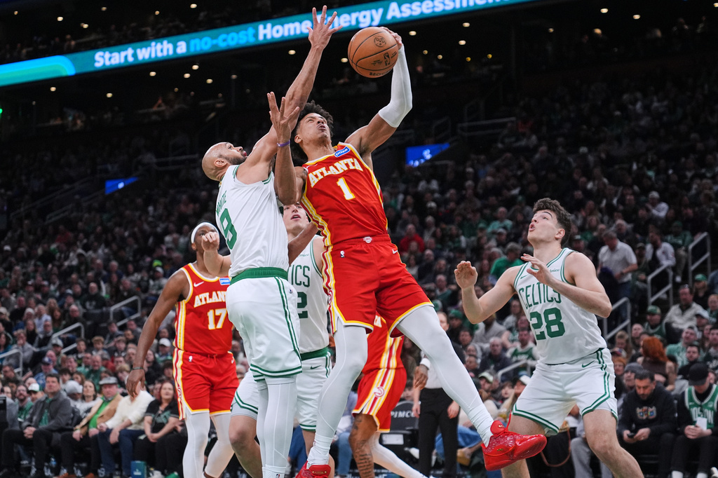 Atlanta Hawks forward Jalen Johnson drives to the basket against the Boston Celtics center during the second half of an NBA basketball game, Friday, March 27, 2026, in Boston. (AP Photo/Charles Krupa)